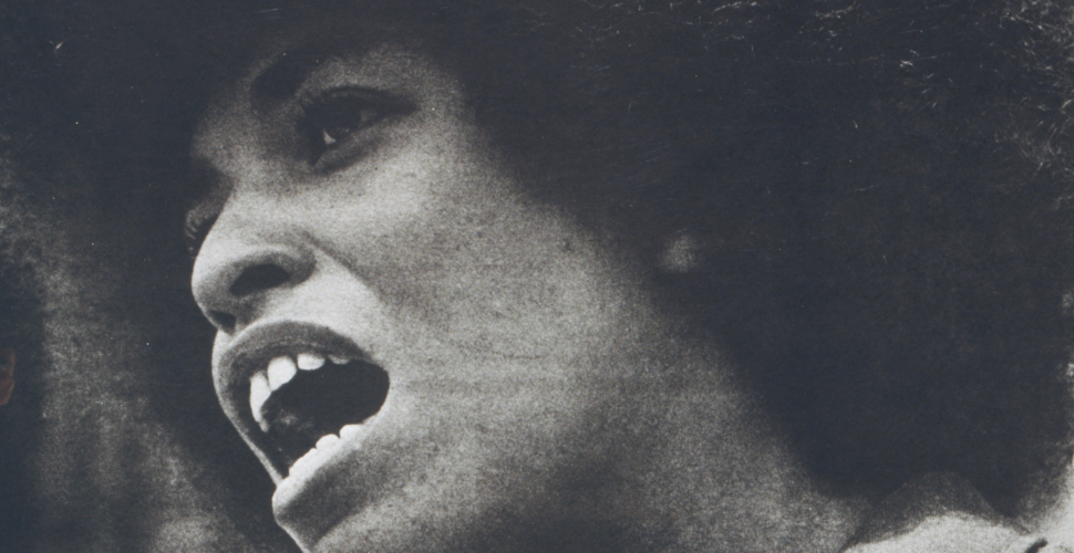 Black and white close-up of Angela Davis speaking passionately, symbolising courage, activism and the fight for justice and equality.